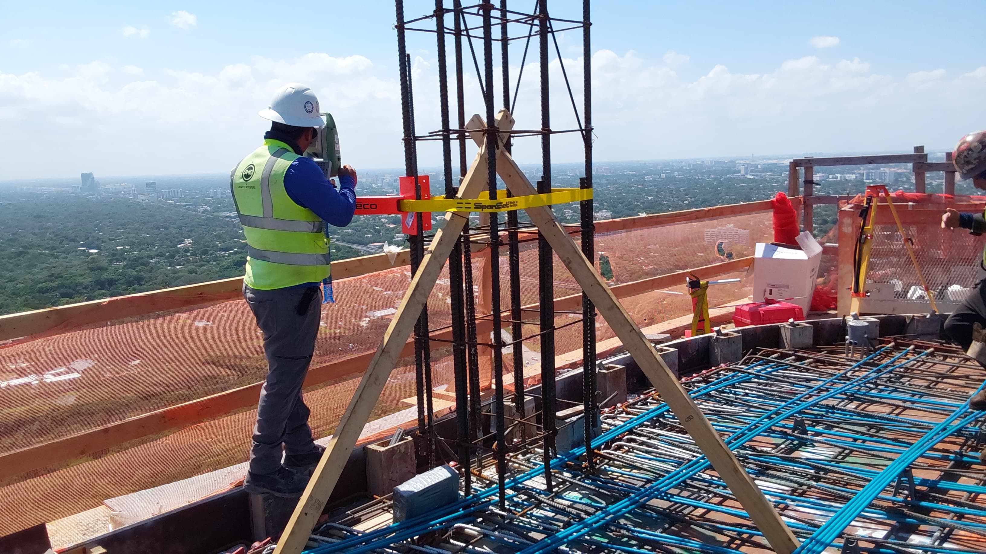 JHA Land Surveyor working on a high-rise construction site in Florida